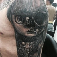 Impressive looking very detailed shoulder tattoo of half normal half skeleton doll