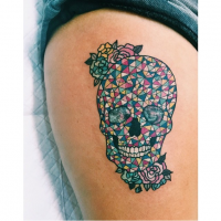 Impressive ornamental style colored thigh tattoo of cool skull with flowers