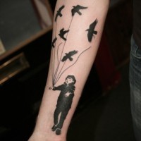 Tatuaje en el antebrazo, chico con aves atadas a cuerdas, tinta negra