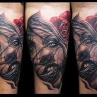 Impressive painted realistic looking woman face tattoo on forearm with red rose
