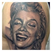Impressive realistic black ink Merlin Monroe portrait tattoo on shoulder