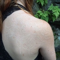 Impressive white ink painted massive shoulder tattoo of flowers