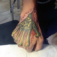 Impressive zombie like colored skeleton hand tattoo on fist