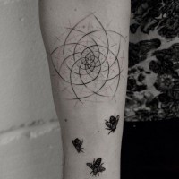 Incredible black ink abstract flower shaped tattoo on forearm stylized with little bees