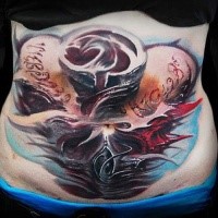 Incredible colored belly tattoo of mystical skull with lettering