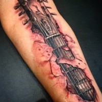 Tatuaje en el brazo,
guitarra eléctrica fascinante debajo de la piel en sangre