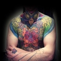 Incredible looking colored chest and shoulder tattoo of mystical bird and flowers