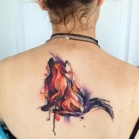 Incredible naturally colored fox tattoo on back in watercolor style