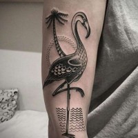 Interesting black ink big flamingo tattoo on arm stylized with palm tree