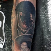 Interesting colored antic warrior tattoo on forearm