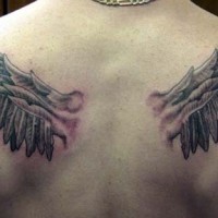 Interesting colored bloody broken wings tattoo on upper back