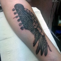 Interesting combined black and white guitar with feather tattoo on arm
