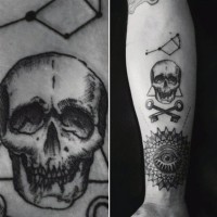 Interesting combined black and white skull with keys tattoo on arm