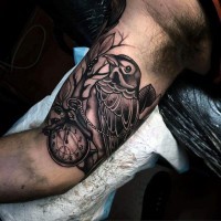 Interesting combined black ink bird with clock tattoo on arm