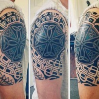 Interesting combined black ink tribal ornaments with colored Celtic cross half sleeve like tattoo