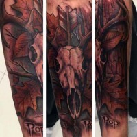 Interesting combined colored animal skull with arrow and lettering tattoo on sleeve