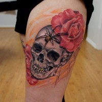 Interesting combined colored rose flowers tattoo on thigh combined with human skull and spider