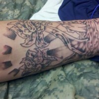 Interesting gray-ink flowers growing from water tattoo sleeve on forearm
