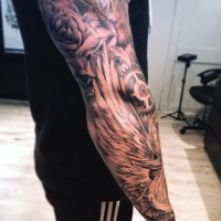 Tatuaje en el brazo, dibujo negro blanco de mecanismos diferentes y alas