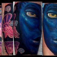 Interesting painted colorful Avatar hero portrait tattoo on forearm zone