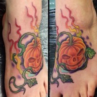 Interesting painted little cartoon pumpkin tattoo on foot