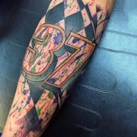 Interesting racing themed colored tattoo on arm