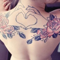 Interesting themed colored flowers with heart shaped hands tattoo on upper back