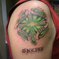 Irish clover with dates of birth tattoo on shoulder