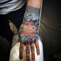 Japanese style colored hand tattoo of daruma doll with lettering and chrysanthemum
