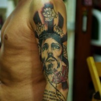 Jesus with red roses and text of bible tattoo on shoulder