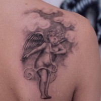 Joyful small angel tattoo