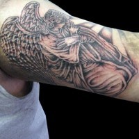 Tatuaje en el brazo, ángel arrodillado