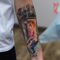 Lantern with a candle tattoo on arm