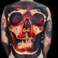 Large 3D style colored back tattoo of big human skull