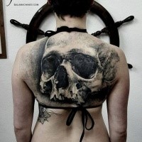Large 3D style upper back tattoo of human skull