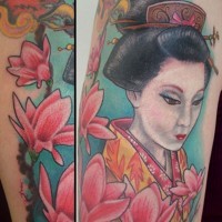 Large beautiful painted and colored shoulder tattoo of Asian geisha and flowers