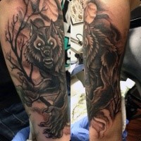 Large black and white leg tattoo of werewolf in dark forest
