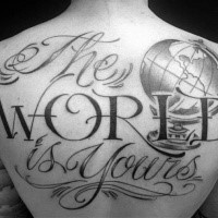 Large black ink back tattoo of large lettering with globe