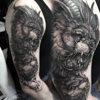 Large black ink mystical lion with goat horns tattoo on shoulder