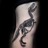 Large black ink side tattoo of dinosaur skeleton