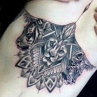Large blackwork dot style tattoo of various wild cats with floral ornaments