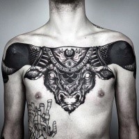 Large blackwork style mystical chest tattoo of big demonic bulls head stylized with cult symbol