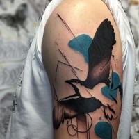 Large colored abstract style shoulder tattoo of flying bird