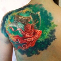 Large colored shoulder tattoo of illustrative style woman with harp