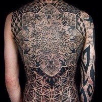 Large colored whole back tattoo of large ornamental flower