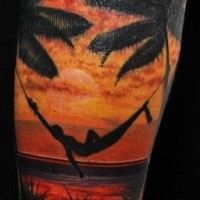 large colorful forearm tattoo of human on beach with palm trees