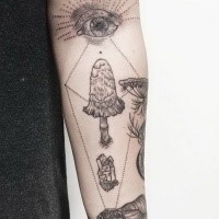 Large forearm tattoo of human eye with mushroom and crystal