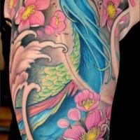 Large illustrative style colored shoulder tattoo of peacock with flowers