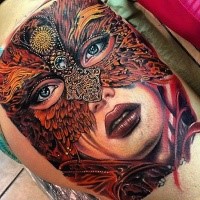 Large nice looking tattoo of beautiful woman face stylized with gorgeous mask