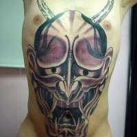 Large oni face tattoo on chest